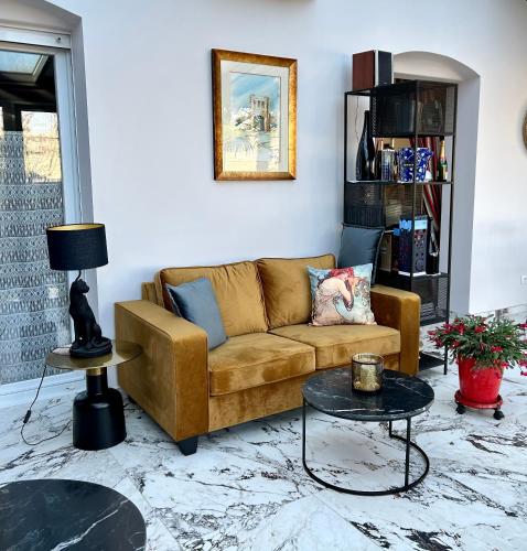 a living room with a couch and a table at Les Suites Champenoises in Reims