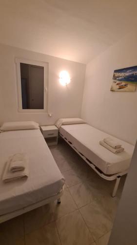 a hospital room with two beds and a window at Villas Estrellas 11 in Ciutadella