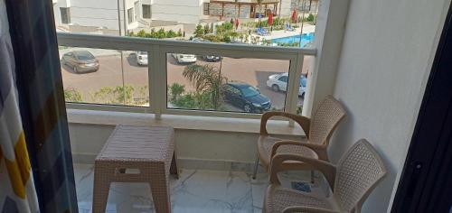 a balcony with two chairs and a table and a window at شاليه للايجار اليومى بورتو سعيد in Port Said