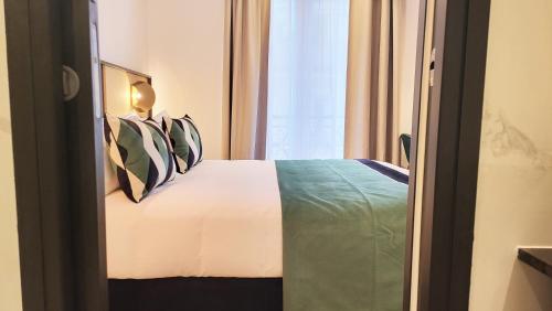 a bedroom with a bed and a window at Star Champs-Elysées in Paris