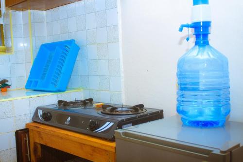 a bottle of water sitting on top of a stove at Lux Suites L&N Apartments Utawala in Embakasi