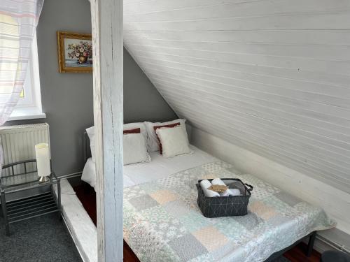 a small room with a bed in a attic at Penzion Pomodoro in Vrbno pod Pradědem