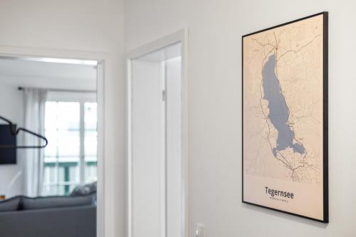 a map hanging on a wall in a living room at Casa Tegernsee - zentral, modern, Nespresso, 3 Min zum See in Gmund am Tegernsee