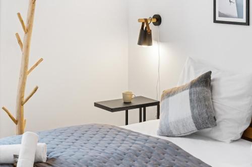 a bedroom with a bed and a side table at Casa Tegernsee - zentral, modern, Nespresso, 3 Min zum See in Gmund am Tegernsee