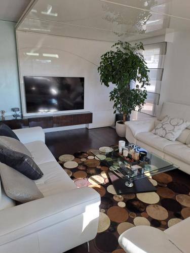 a living room with a couch and a table at Parisian Sparkle Retreat in Neuilly-sur-Seine