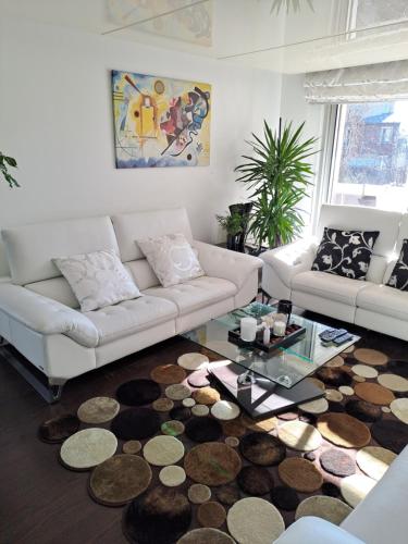 a living room with a couch and a coffee table at Parisian Sparkle Retreat in Neuilly-sur-Seine