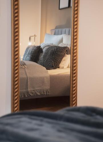 a bedroom with a bed in a mirror at St. Salvator Apartments in Fulda