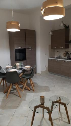 a kitchen and dining room with a table and chairs at CIVICO 16A - Apartment - with private parking in Quartu SantʼElena