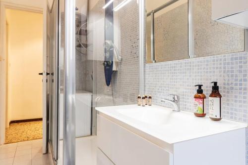 a white bathroom with a sink and a shower at Piola Flexyrent apt. A.C. WiFi in Milan