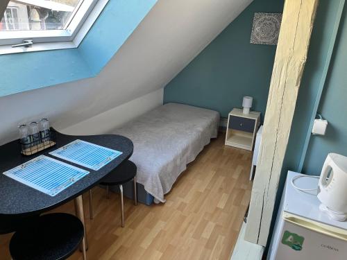 a small room with a bed and a table at Penzion Pomodoro in Vrbno pod Pradědem