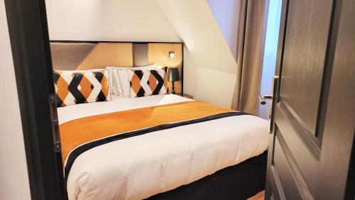 a bedroom with a large bed with a wooden headboard at Star Champs-Elysées in Paris