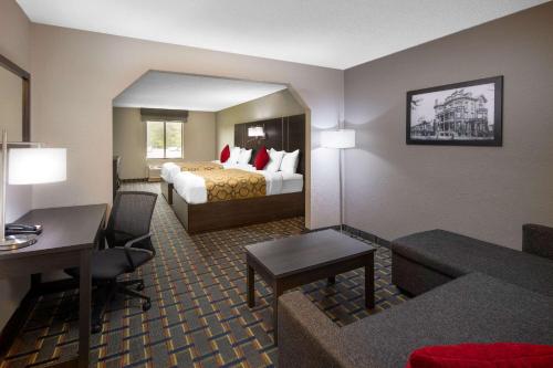 a hotel room with a bed and a desk at Baymont by Wyndham Pooler/Savannah in Savannah