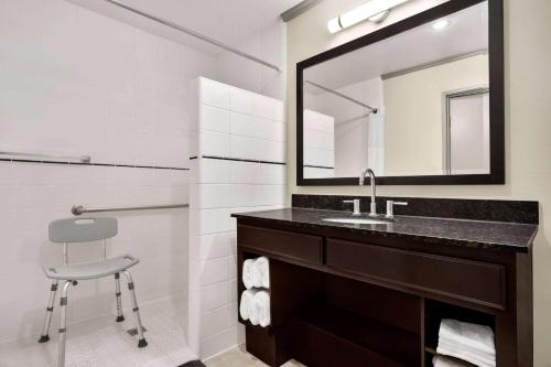 a bathroom with a sink and a mirror at Baymont by Wyndham Monterey Park in Monterey Park