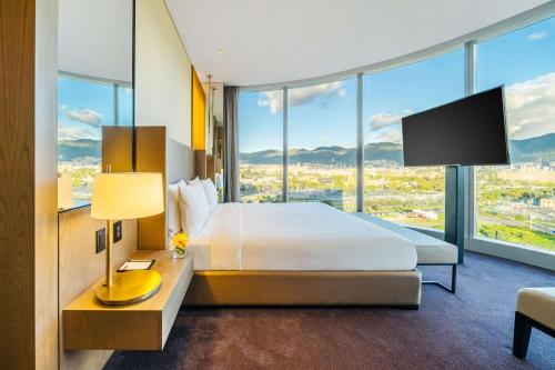 a hotel room with a bed and a large window at Grand Hyatt Bogota in Bogotá