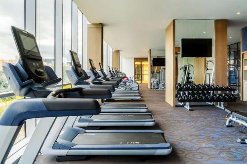 a gym with a row of treadmills and machines at Grand Hyatt Bogota in Bogotá