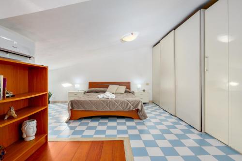 um quarto com uma cama e um piso em xadrez em L'appartamento di Giusi em Olbia