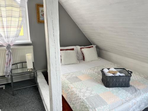 a small bedroom with a bed in a attic at Penzion Pomodoro in Vrbno pod Pradědem