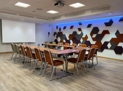 a conference room with a long table and chairs at Radisson Blu Elizabete Hotel, Riga in Rīga