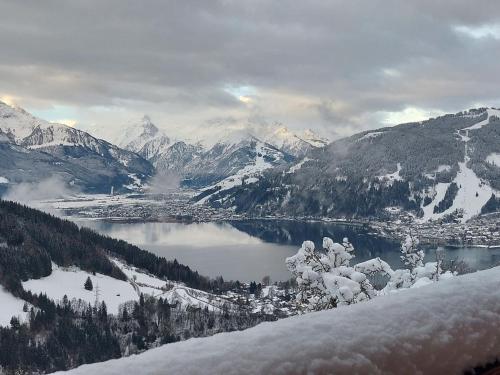 a view of a mountain lake with snow covered mountains at Apartment Unterpirchhof by Interhome in Thumersbach
