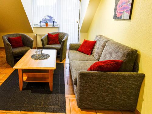 a living room with two couches and a coffee table at Apartment Tjalkstrasse-2 by Interhome in Norddeich