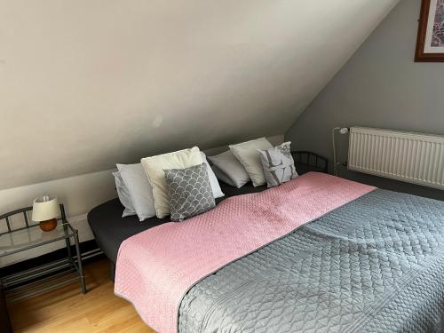 a bedroom with a bed with pillows on it at Penzion Pomodoro in Vrbno pod Pradědem