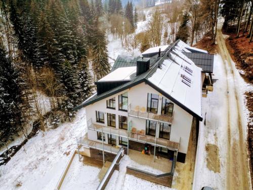 an aerial view of a house in the snow at JASMIN HOME Apartments in Vítkovice