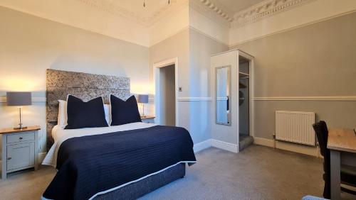 a bedroom with a large bed with a blue comforter at Hotel Ocean in Great Yarmouth