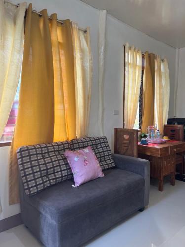 a living room with a couch and a table at JCAH BEACH HOUSE free WiFi in Araceli