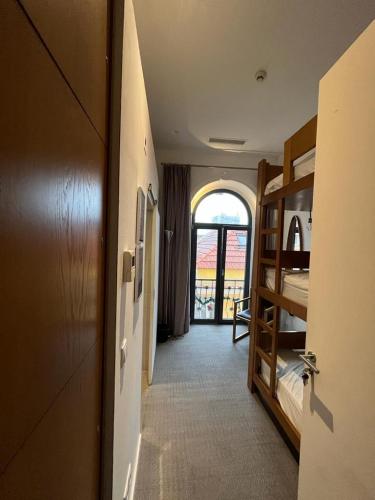 a hallway with a room with bunk beds and a door at Day Off Suite&Hostel in Setúbal