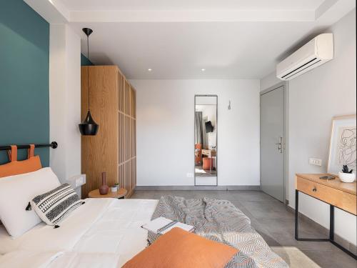 a bedroom with a large bed and a mirror at Elia Bettolo Hotel in Chania Town