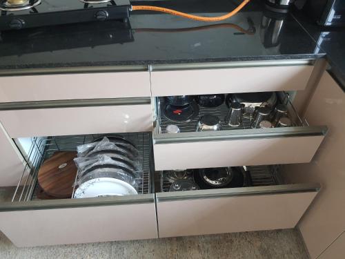 a drawer in a cabinet filled with wine bottles at Castle Dollars in Bengaluru