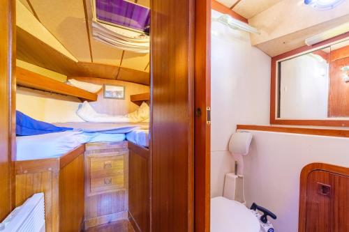 a small room with two bunk beds and a toilet at Voilier de 12m à Quai Port Canto in Cannes