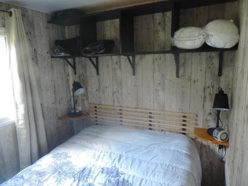 - une chambre avec un lit doté de murs en bois et d'étagères dans l'établissement mobil home dans camping 3 etoiles mas de lastourg avec piscine,snack,, à Villefranche-de-Conflent