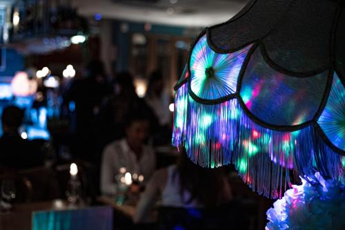 a woman wearing a hat with colorful lights on it at Reimersholme Hotel in Stockholm