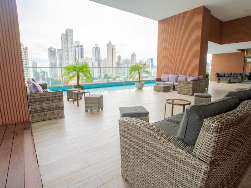 a living room with couches and chairs in a building at Boutique Apartments Panamá Coco del Mar in Panama City