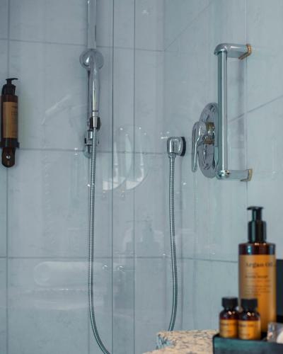 a shower in a bathroom with a glass shower stall at Romantik Hotel-Restaurant Altenberger Hof in Odenthal