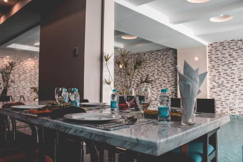 a long table with plates and bottles of water on it at Velvet Hotel Jeddah in Jeddah