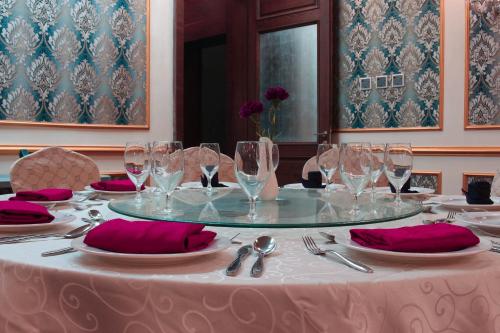 a table with wine glasses on top of it at Velvet Hotel Jeddah in Jeddah