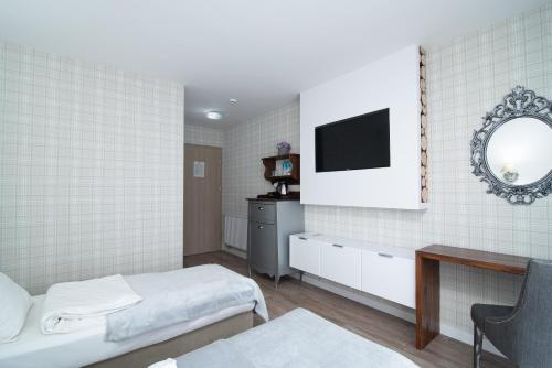 Postel nebo postele na pokoji v ubytování Adler Medical SPA Kaszuby