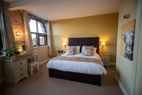 a bedroom with a large bed and a window at Tower Barn Cottage, Castle Carrock, Nr Carlisle in Castle Carrock