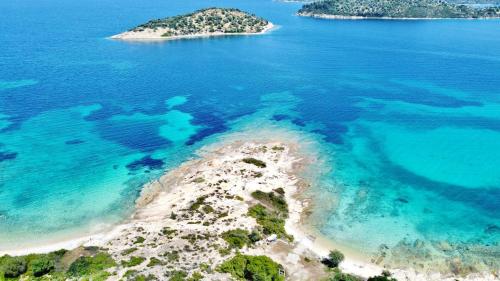 an aerial view of an island in the ocean at Nereus & Oceanus Beachfront Apartments, Lagonisi Beach #FeelsLikeHome in Ormos Panagias