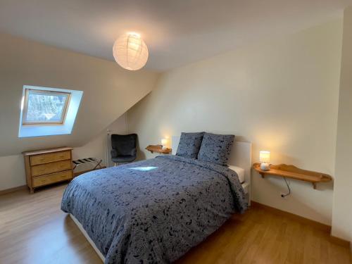 a bedroom with a bed and a chair and lights at Le Mulberry in Bayeux
