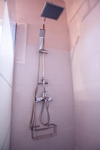 a shower with a shower head in a bathroom at The Homey in Sidari