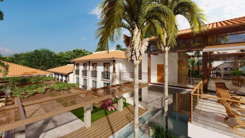 - une vue aérienne sur une maison avec des palmiers dans l'établissement Quarto em Quinta Santa Bárbara Ecoresort, à Pirenópolis