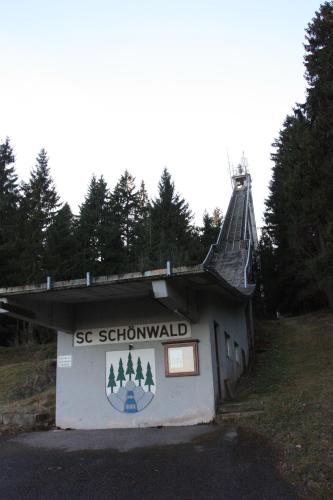 a building with a sign on the side of it at Hotel an der Sonne & Restaurant Zum Schneiger in Schonwald im Schwarzwald
