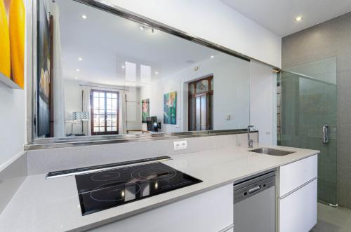 a kitchen with a sink and a mirror at YourHouse Can Bombarda for groups up to 10 guests, perfect for cycling in Llubí
