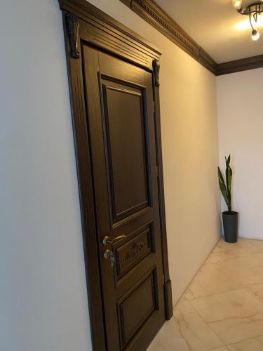 a wooden door in a room with a plant at Едем in Brzezhany