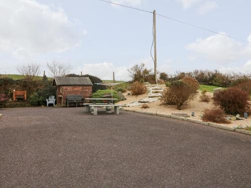 a park with a picnic table and a building at Raheen in Castletownshend