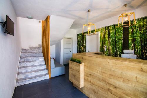 a house with a staircase and a lobby at Philoxenia Suites in Nea Vrasna