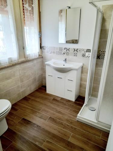 a bathroom with a sink and a toilet at La Casera in Lido di Dante